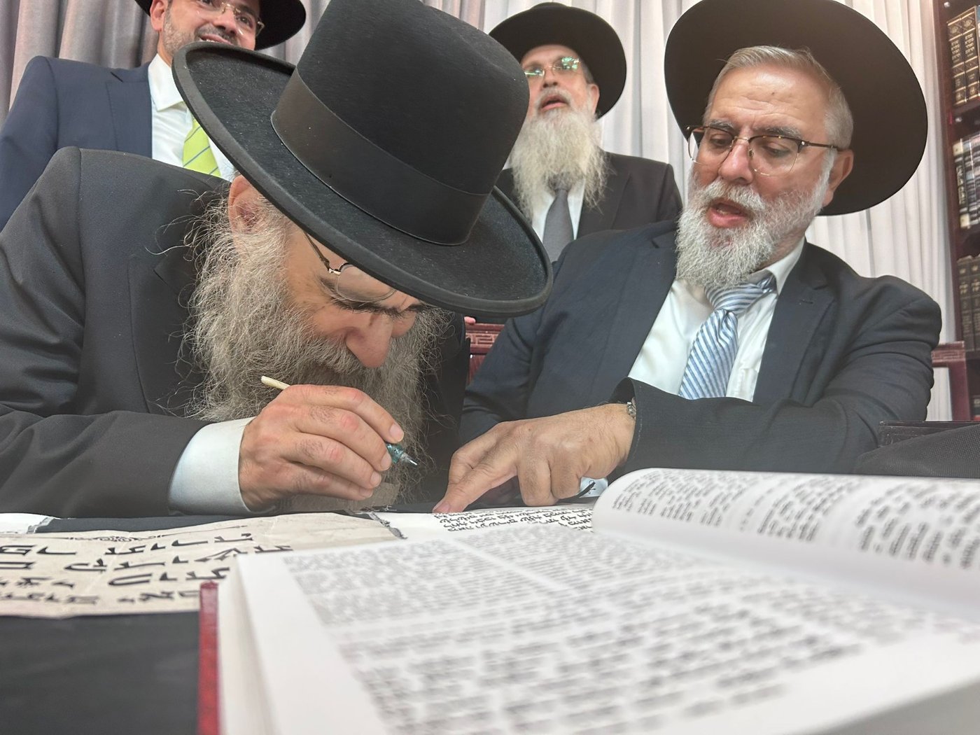 גדולי ישראל בכתיבת אות בספר התורה בביתו של הפוסק | תיעוד