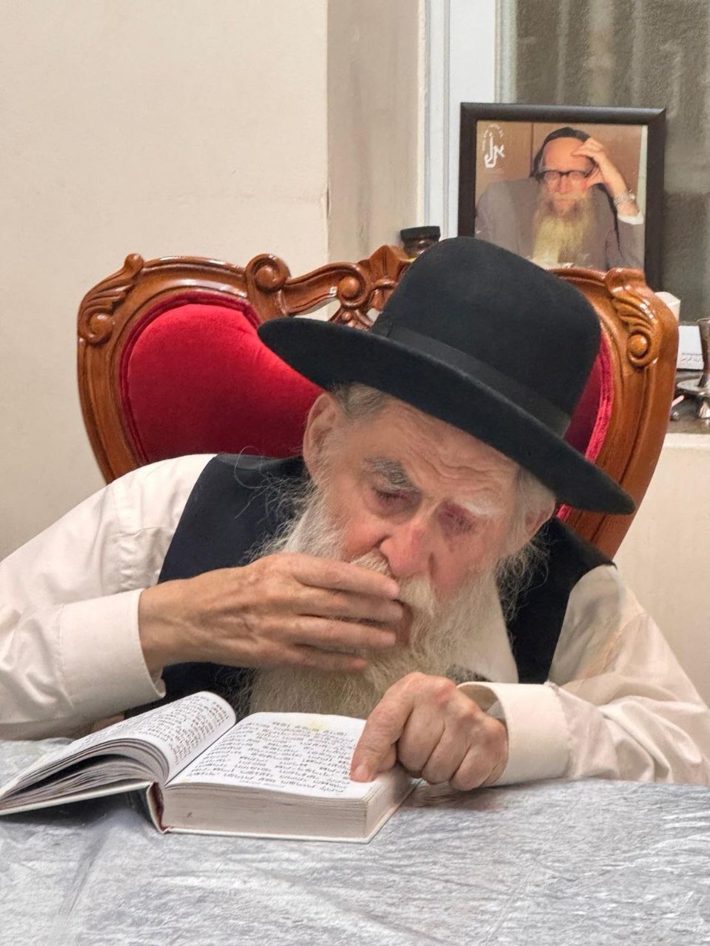 חכם משה חיים אריה זצ"ל ומאחוריו תמונתו של הצדיק רבי ששון מזרחי זצ"ל