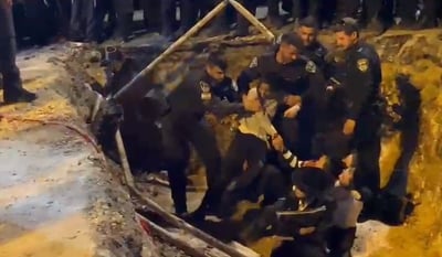 שוטרים שולפים קטין מפגין מבור