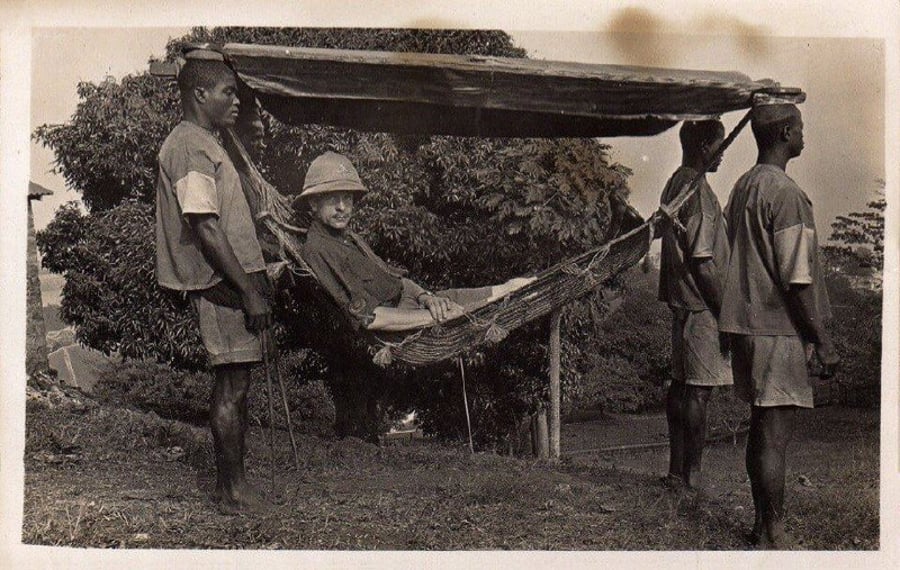 חייל בריטי מתפנק בערסל מוצל שמובל בידי אזרחים מקומיים, בזמן שארצו כבשו את המקום. סיירה לאון 1920