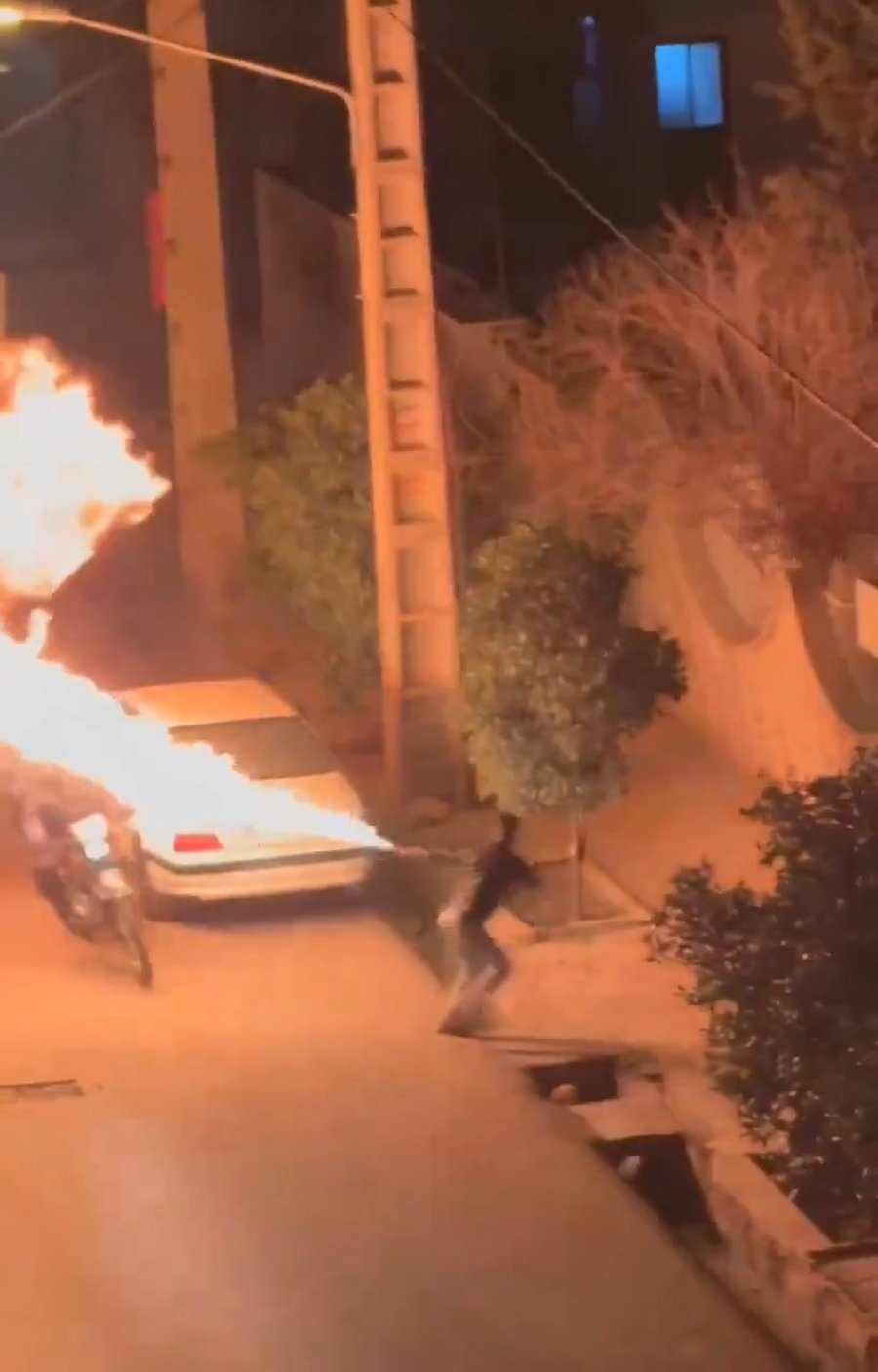 מפגין מבעיר אנשי משטרה באיראן